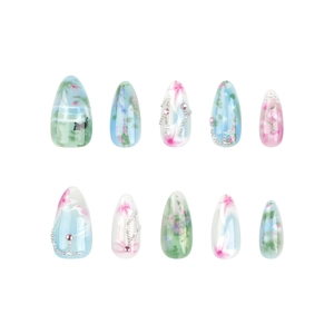 Almond-shaped press-on nails with blue floral ink patterns and 3D rhinestone beads