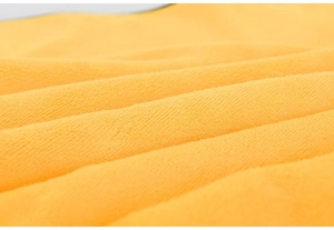 Macro shot of bright yellow coral fleece fabric texture for absorbent pet towels