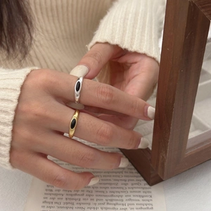 Detail of vintage 925 sterling silver rings with black agate stones on a knit sweater