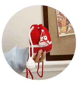 Detailed view of red handmade crochet Christmas drawstring bag with cute snowman motif.