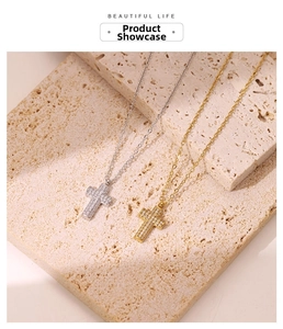 Close-up of gold and silver cross necklaces with micro-pave crystals on stone