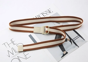 Close-up of brown and beige striped canvas belt with a white square metal buckle