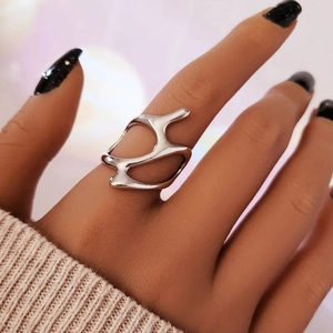 Detail of silver liquid metal style ring with irregular streamlined hollow structure
