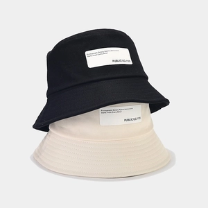 Classic cotton bucket hats in black and beige with vintage patch details for sun protection