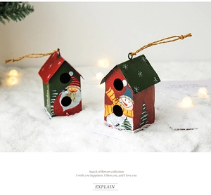 Close-up of two miniature Christmas house ornaments with Santa and snowman patterns