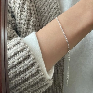 Close-up of minimalist S925 sterling silver thin chain bracelet with extension on wrist