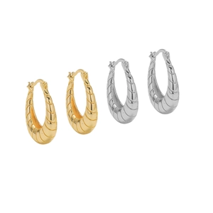 Textured gold and silver croissant hoop earrings with horizontal ribbed metal finish