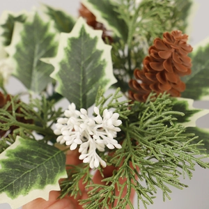 Christmas candle ring with snowy holly leaves, pine cones, and white berries decor