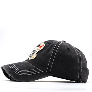 Detailed close-up of dark grey washed cotton baseball cap with Dog Vibes Only embroidery