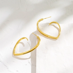 Elegant 14K gold plated heart earrings on a marble surface with soft natural lighting