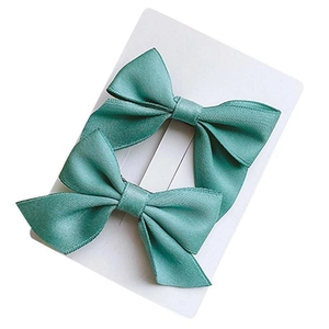 Pair of elegant teal satin bow hair clips for girls on white display card