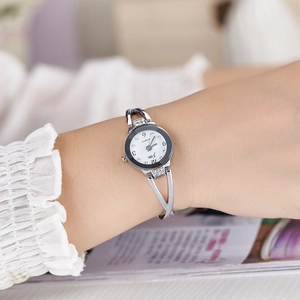 Fashionable women's silver quartz watch with a crystal-studded bangle style steel strap