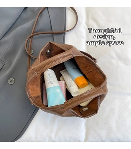 Interior view of brown leather bucket bag showing magnetic closure and spacious room