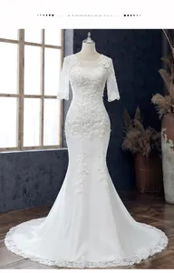 Details eines weißen Meerjungfrau-Brautkleids aus Spitze mit floralen Applikationen