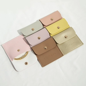 Multiple colors of PU leather jewelry pouches with snap buttons and embossed Vinknde logo