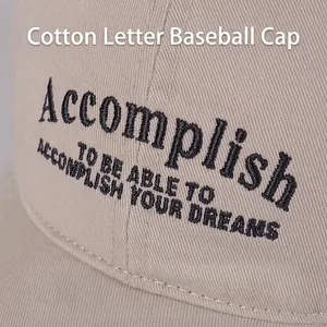Cotton baseball cap with Accomplish embroidery in khaki shown in a detailed close-up shot