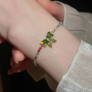 Close-up of sparkling zircon butterfly charm bracelet with colorful crystal beads