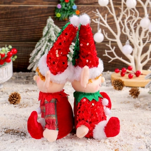 Cute Christmas elf plush dolls with sequin hats set in a warm snowy holiday scene