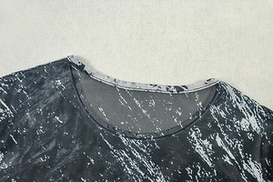 Detail of crew neck collar featuring black and white abstract print on mesh fabric