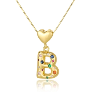 Macro detail of gold letter B pendant with colorful zircon stones and heart bail