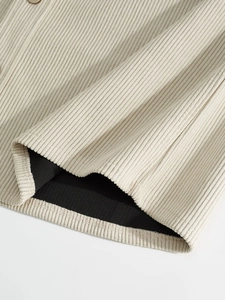 Detailed macro view of beige corduroy fabric texture and high-quality hem stitching