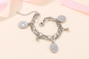 Detailed close-up of double layer steel bracelet with sun and moon oval coin charms