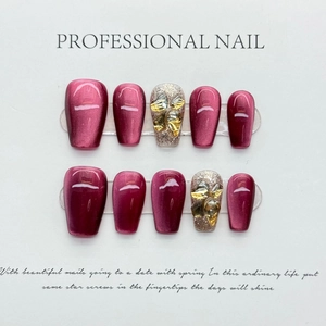 Cat eye press-on nails set in deep rose red with silver glitter and rhinestone accents