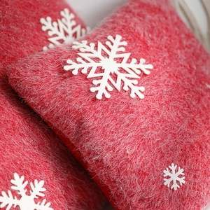 Red Christmas pillow with white snowflake pattern for festive sofa and home decoration