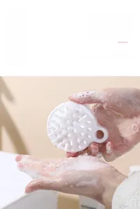 Detail showing soft silicone massage brush creating rich foam for scalp cleaning