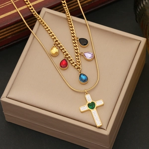 Double layer gold necklace with colorful teardrop charms and a diamond cross pendant