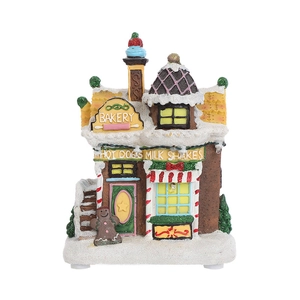 Detailed view of LED gingerbread house bakery with faux snow and gingerbread man decor