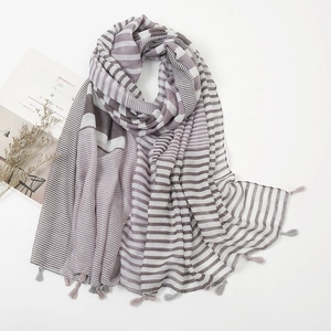 Detailed view of striped linen scarf with small fringe tassels in purple and grey