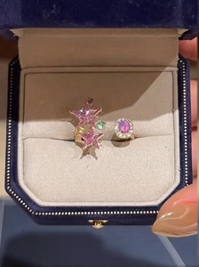 Detail of gold-plated open ring featuring pink star gems and micro-pave crystals