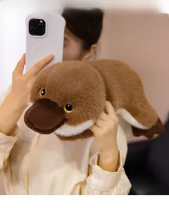 Close-up of fluffy brown platypus plush toy showing soft texture and sparkly eyes