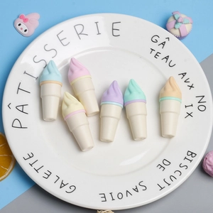 Set of colorful ice cream shaped erasers in macaron tones on a white decorative plate
