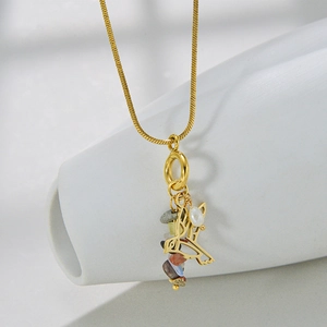 Macro detail of bird pendant necklace with colorful natural stones and pearl