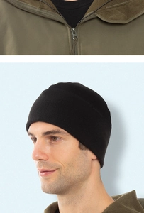 Detail of army green jacket collar paired with a black outdoor fleece beanie for winter sports