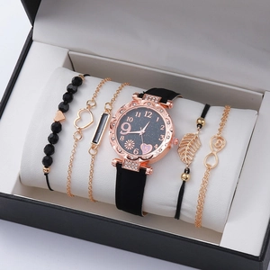 Women's black starry dial quartz watch set with four gold-tone heart and leaf bracelets
