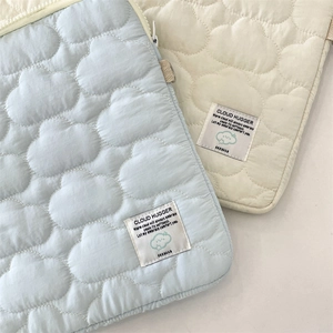 Detailed view of quilted cloud texture and soft woven label on tablet sleeve cases