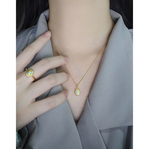 S925 sterling silver gold necklace and ring set with oval blue opal on a model