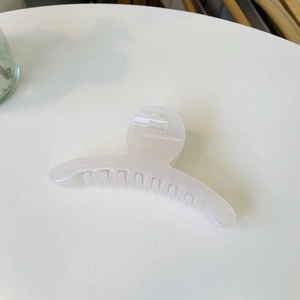 Elegant pearl white curved hair claw clip with a glossy finish for a minimalist look