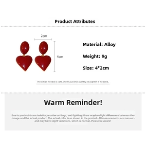 Detail view of red heart drop earrings showing dimensions 4x2cm and weight 9g specs