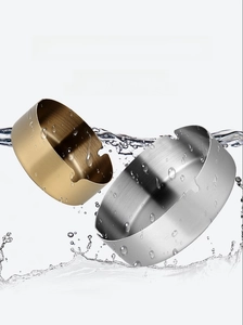 Detail of gold and silver stainless steel ashtrays with water splash effect showing waterproof finish