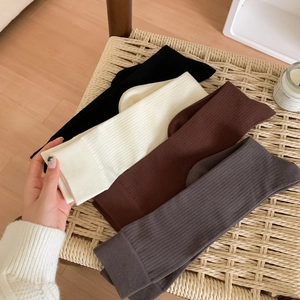 Calf-length combed cotton socks in four neutral colors featuring ribbed knit texture