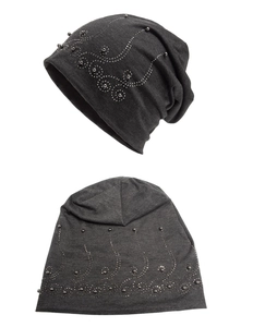 Detail of dark grey slouchy beanie with elegant silver studs and pearl wave patterns