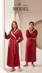 Close-up of thick red couple bathrobe with white piping and soft fleece texture