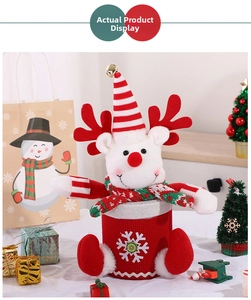 Close-up of reindeer Christmas candy jar with red knit texture and festive bells