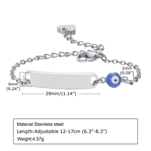 Detail of adjustable stainless steel child bracelet with evil eye bead and engraving bar