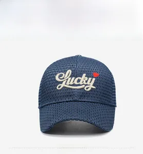 Detail of navy mesh baseball cap with white Lucky embroidery and small red heart