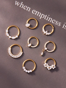 Detail of 8pcs gold titanium nose ring set with marquise and round zircon stones